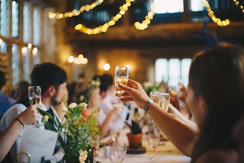 People raising glasses for cheers in an event